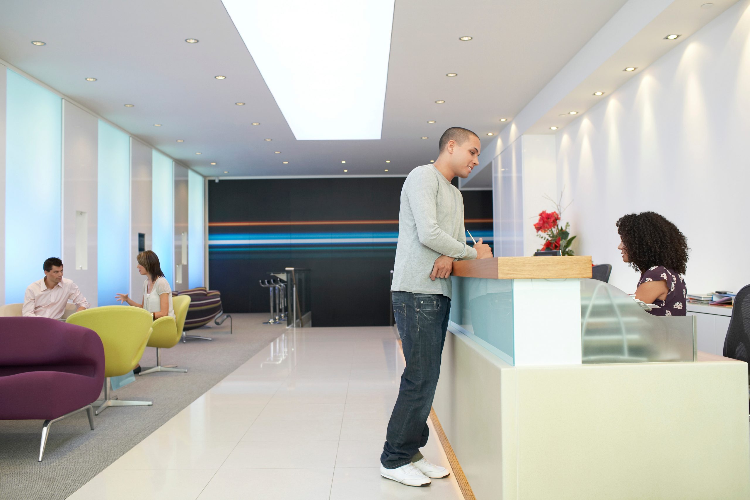 Man Talking To Receptionist At Office